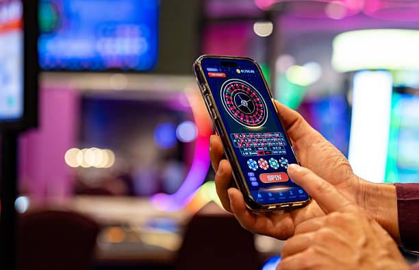 Close-up view of betting chips and French Roulette table with odds displayed